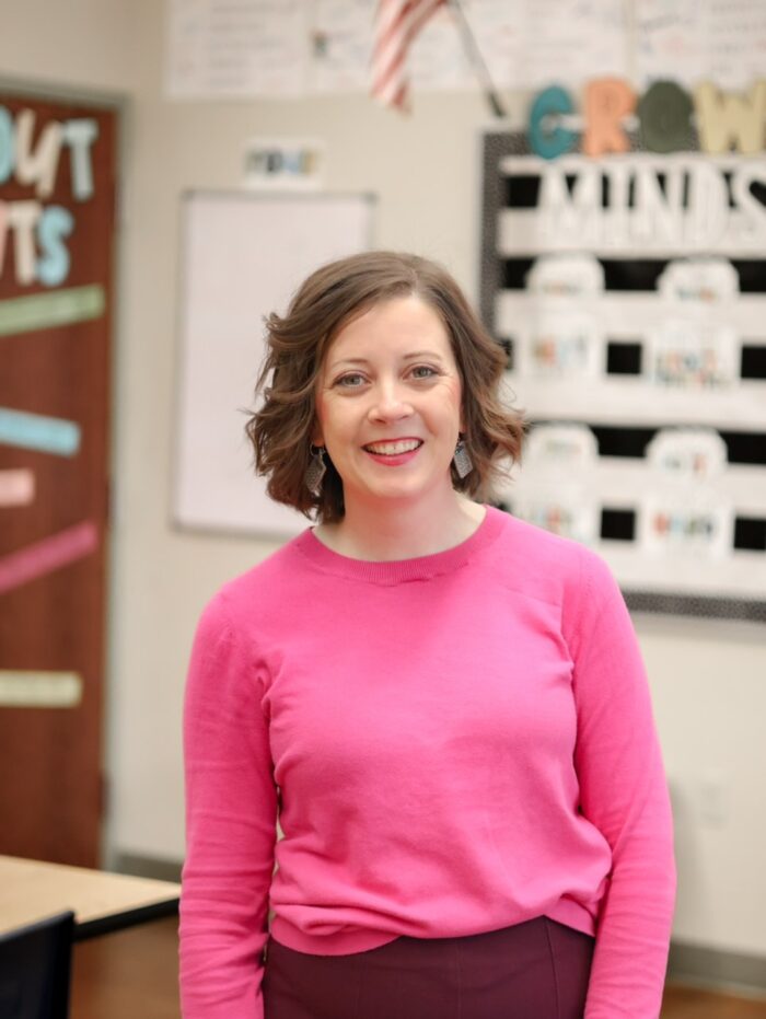 teacher standing in her classroom